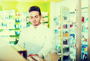 Obraz na płótnie Canvas Man druggist in pharmacy