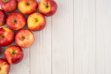 Red apples on the old wooden table.