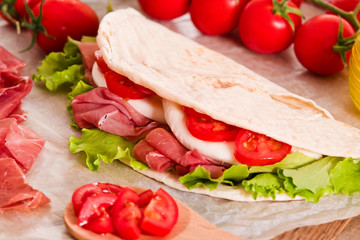 Piadina with ham and lettuce.