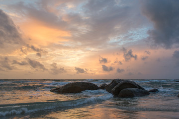 Fototapeta na wymiar Sunset beach with the stone at Phu Quoc island in Vietnam.