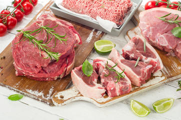 Different types of meat with fresh herbs