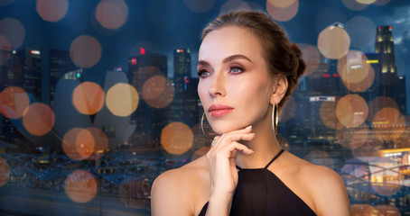 beautiful woman in black wearing diamond jewelry