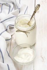 Sour cream in jar and bowl