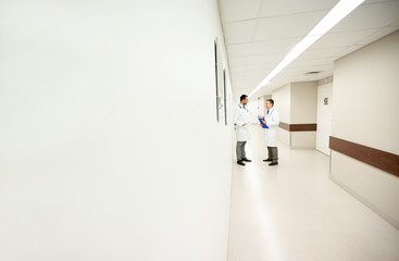 male doctors talking at hospital corridor