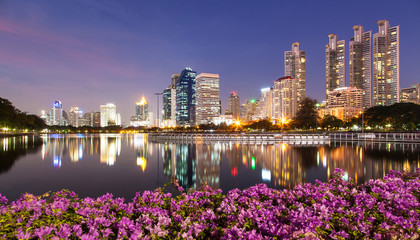 Light in the city, beautiful view, flowers foreground and reflection, Bangkok, Thailand