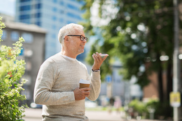 old man using voice command recorder on smartphone - Powered by Adobe