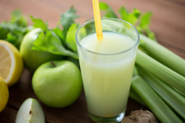 close up of glass with green juice and vegetables