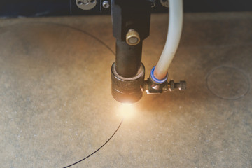  laser machine cutting pattern on acrylic sheet.