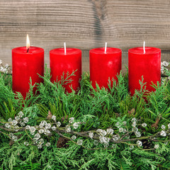 Advent decoration wreath four red burning candles