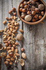 Mixed nuts on old wooden background