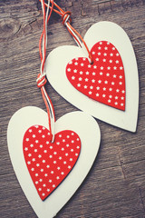 White and red sewed christmas hearts on wooden background,  for greetings Valentine's  day