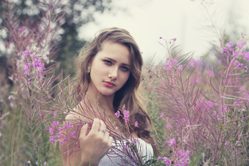 attractive blonde girl in nature in the spring the grass