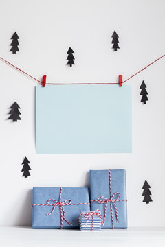 Christmas background mock up with handcrafted presents in white, red, black, and blue colors.