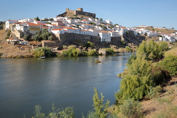 Fototapeta na wymiar MERTOLA, PORTUGAL: General view of the fortified village from the opposite bank of the river Guadiana