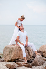 Young couple on the rocks in the sea