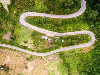 Cercles muraux Photo aérienne Aerial view of crooked path of road on the mountain, Shot from d
