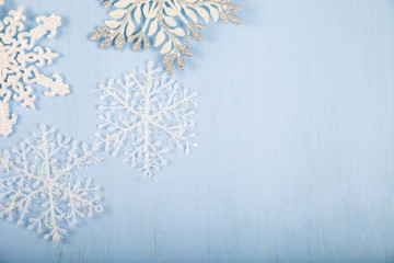 Silver decorative snowflakes on a blue wooden background. Christ