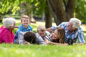 Smiling family lying in the grass