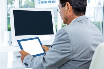 Businessman looking at his tablet 