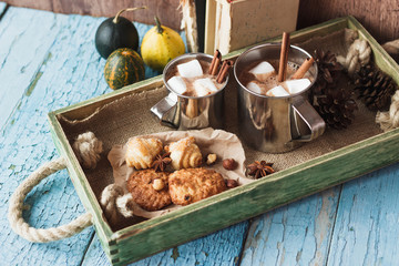 Metal mugs with cacao and marshmallows