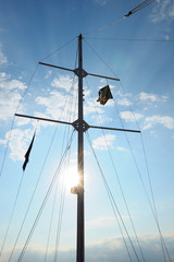 Fototapeta premium Mast on pleasure yacht on blue sky background