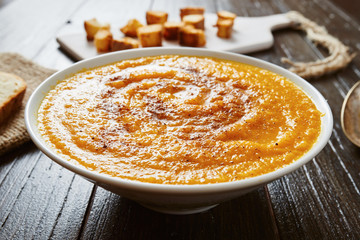 Pumpkin soup in white bowl