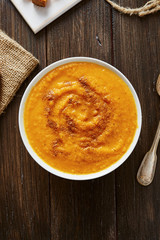 Pumpkin soup in white bowl