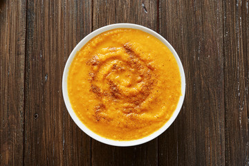 Pumpkin soup in white bowl