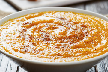 Pumpkin soup in white bowl
