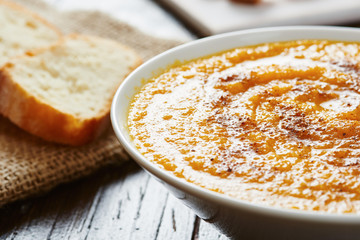 Pumpkin soup in white bowl