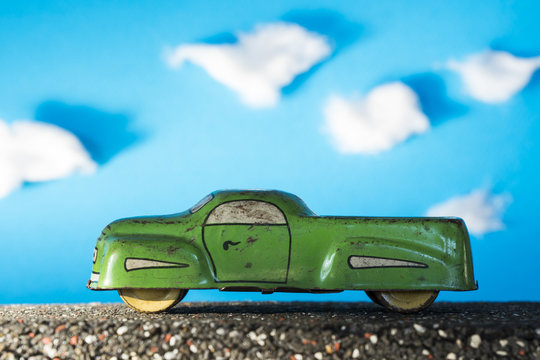 Vintage toy car, green truck on blue background