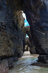 Natural arches on beach.