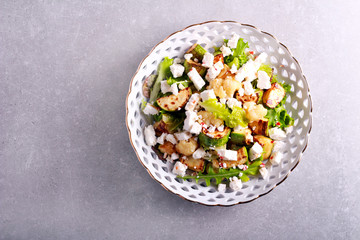 Zucchini, cauliflower and feta salad on plate