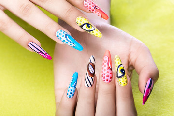 Long beautiful manicure in pop-art style on female fingers. Nails design. Close-up.