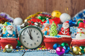 Christmas clock and cupcakes with colored decorations