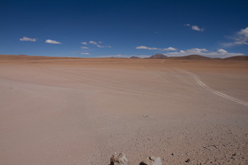 Obraz na płótnie Canvas Desert and mountain over blue sky and white clouds on Altiplano,Bolivia Chile 