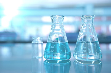 blue glass flask in science lab background