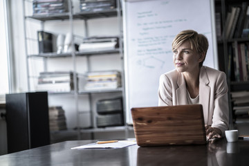 Businesswoman with laptop in modern conference room