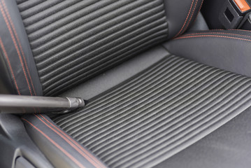 Aspirating the interior of a car.