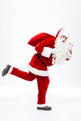Man santa claus holding gift sack and running