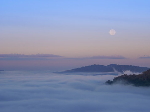 Fototapeta fog in the morning with mountain and moon at Khao Kho, Phetchabun, Thailand