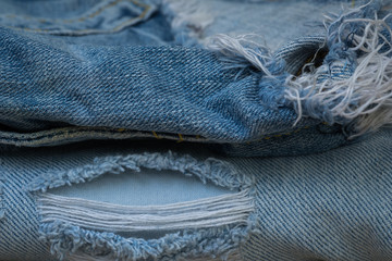 Stack of Torn and worn old jean