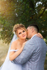 The groom tenderly kissing bride's neck
