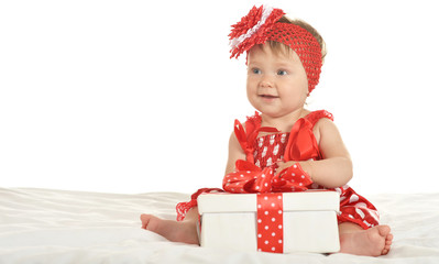 Baby girl in   dress  with gift