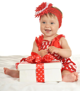 Baby girl in   dress  with gift