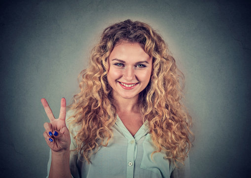Happy teenage girl showing victory or peace sign