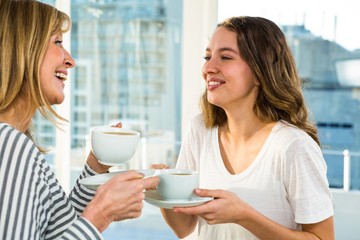 Mother and daughter having tea