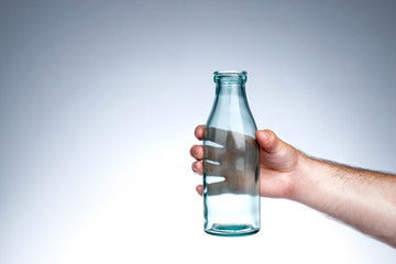 Hand holding old-school milk bottle