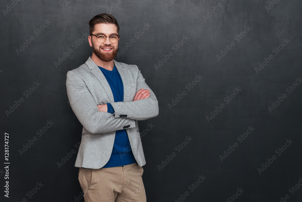 Canvas Prints happy handsome young businessman in glasses standign with arms crossed