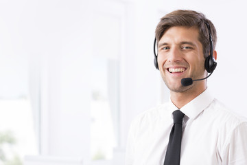 Smiling call-center employee with headphones